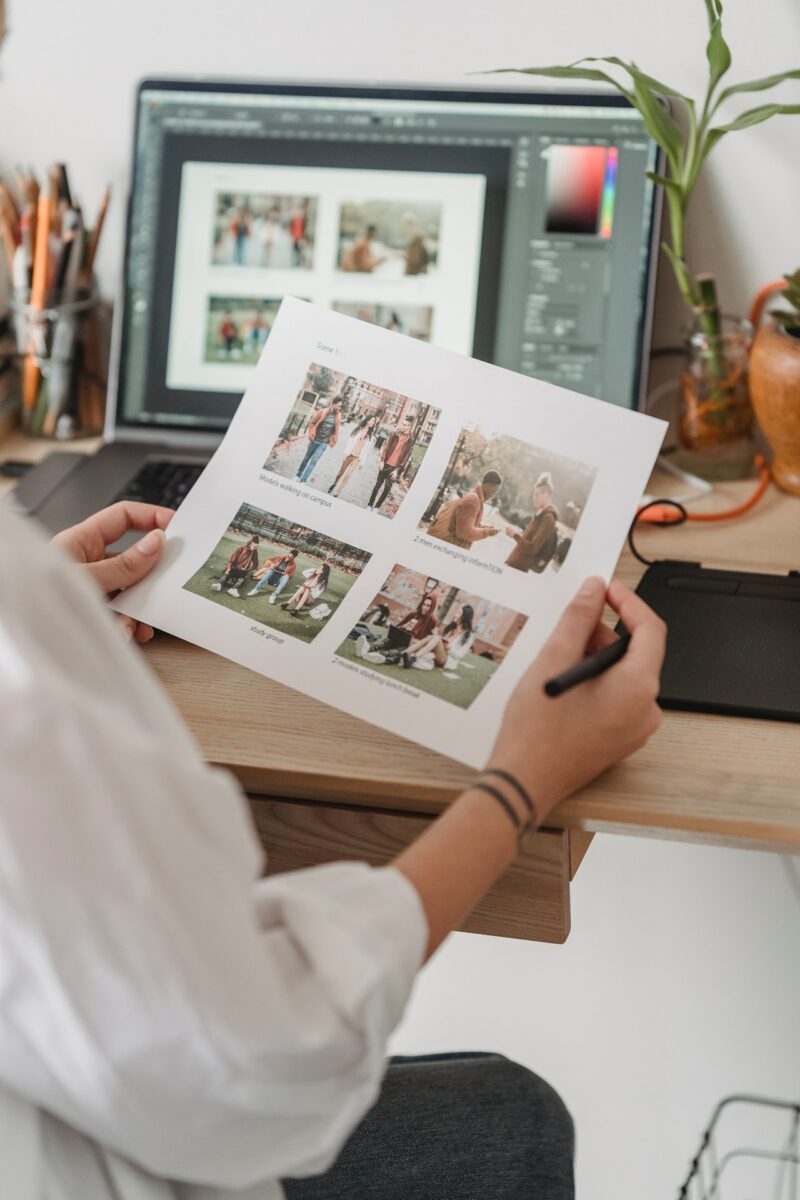 A woman looking at the printed photos while seated on the chair