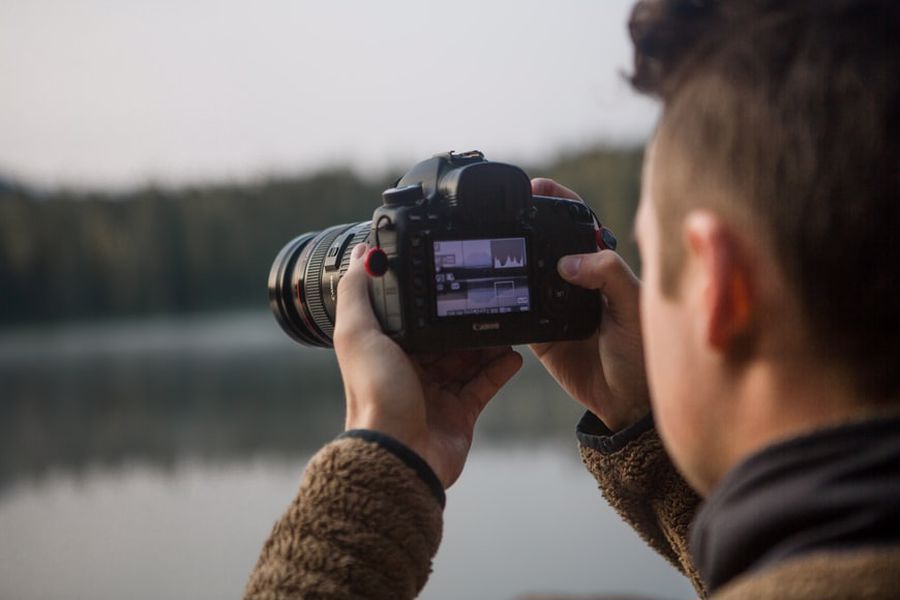 Man reviewing his photos on his camera