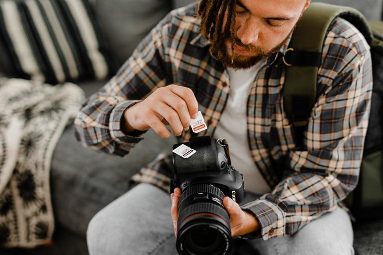 Photographer changing camera memory cards