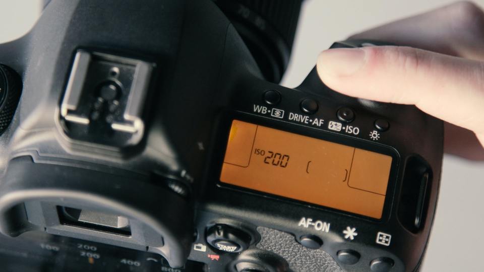 Hand holding a camera with LCD display