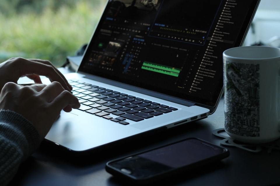 Person editing a video using a laptop