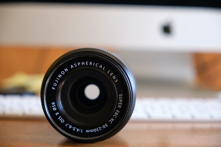An aspherical lens on a wooden desk