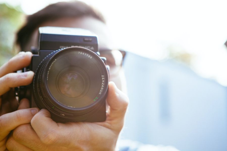 A person taking a photo in daylight