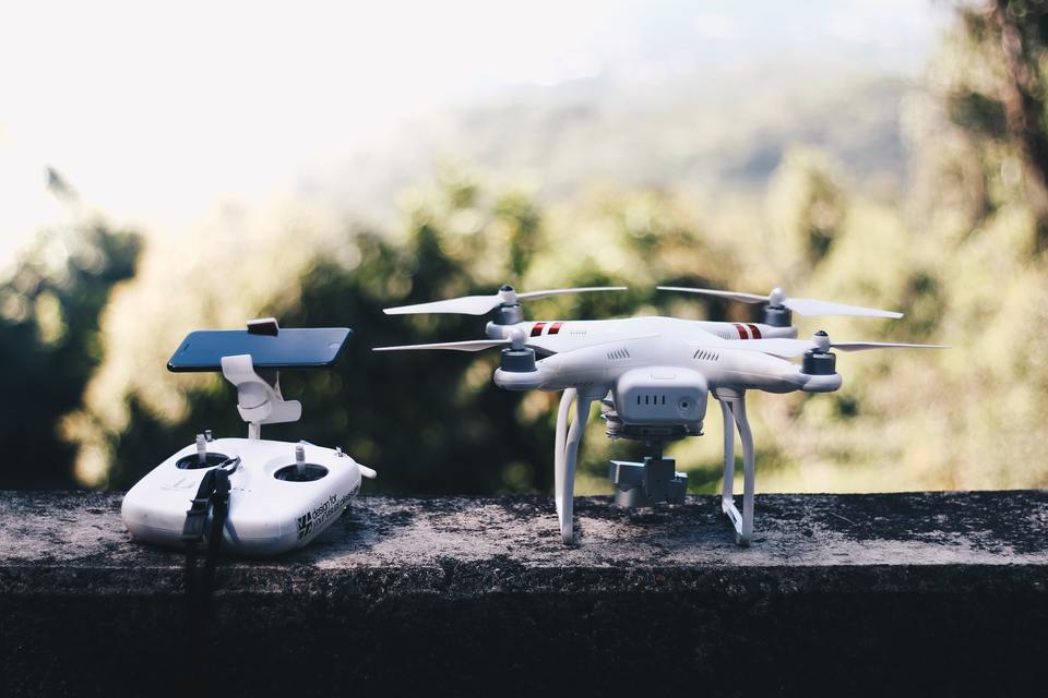 White drone and controller with phone attached