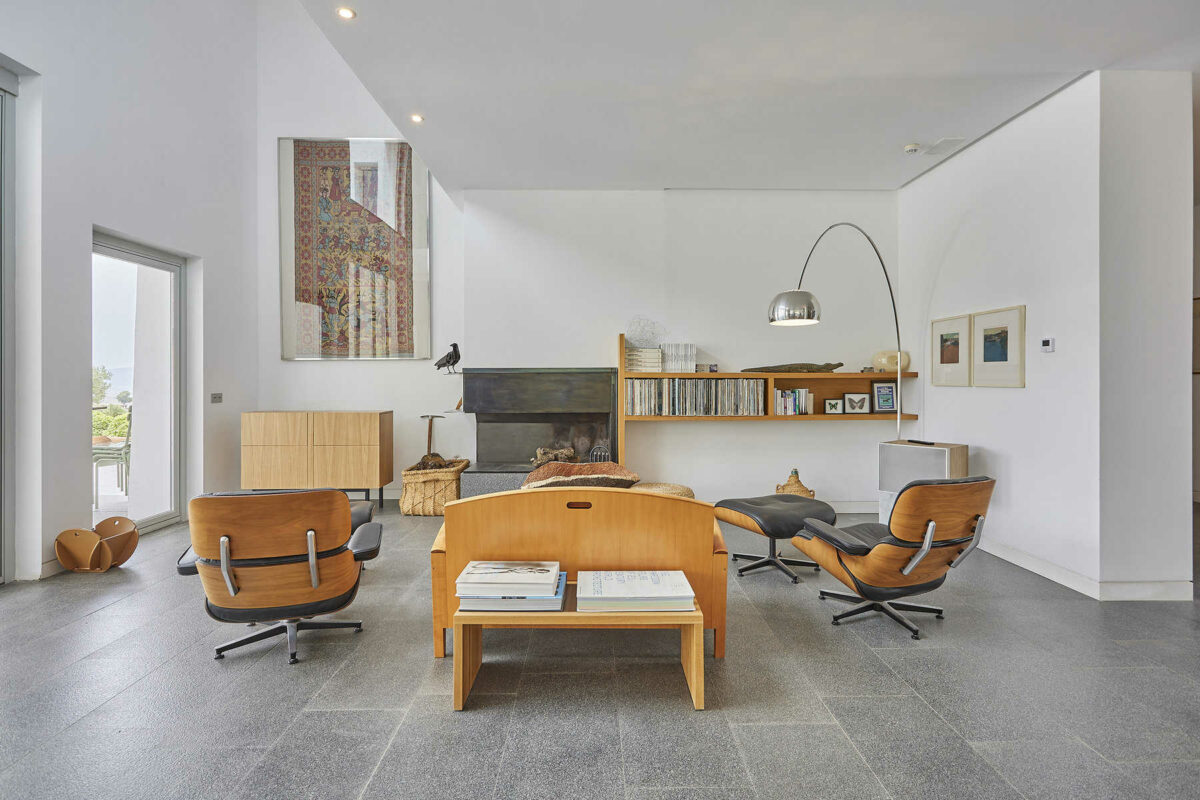 Open living room with matching wooden furnishings and white painted walls