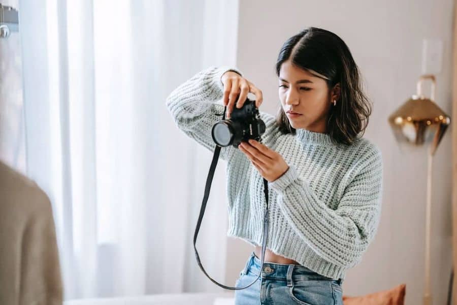 Woman taking a photo of her house interiors