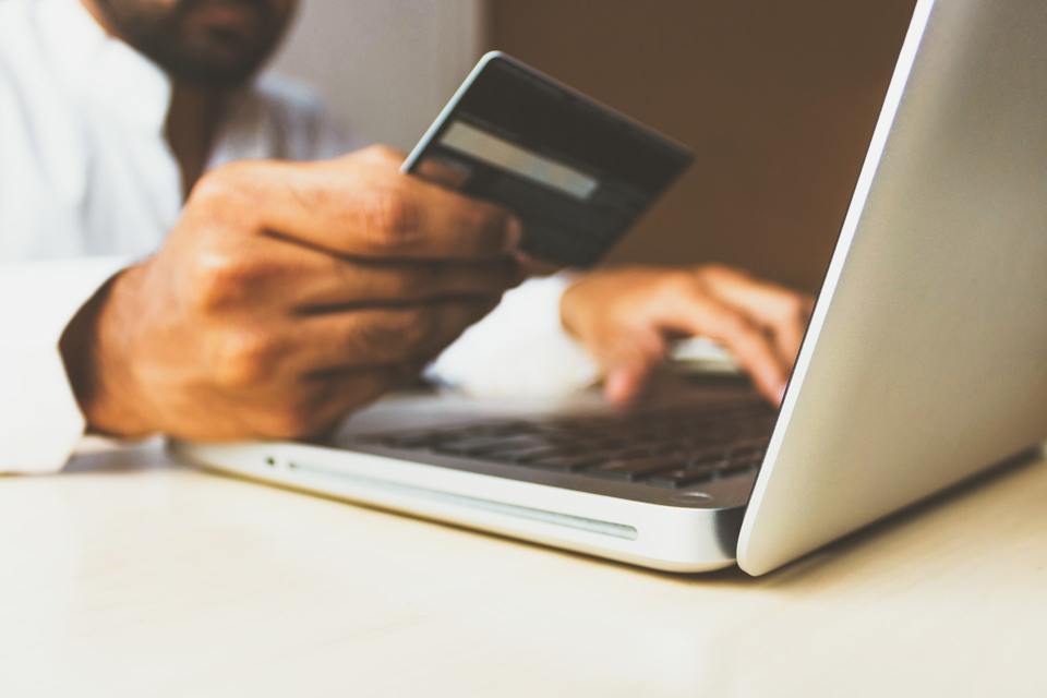 Person using a credit card for online payment