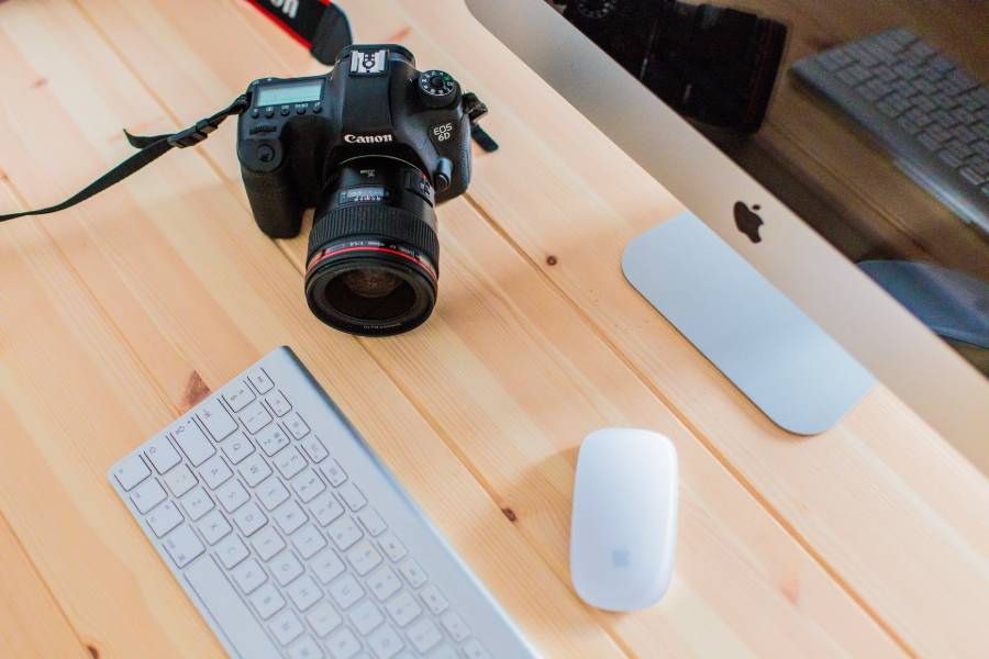 A Canon camera placed on a computer desk