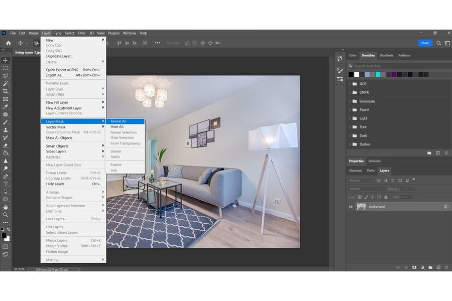 A photo of a living room on a Photoshop with the Layer tab open highlighting the Layer Mask and choosing the Reveal All option