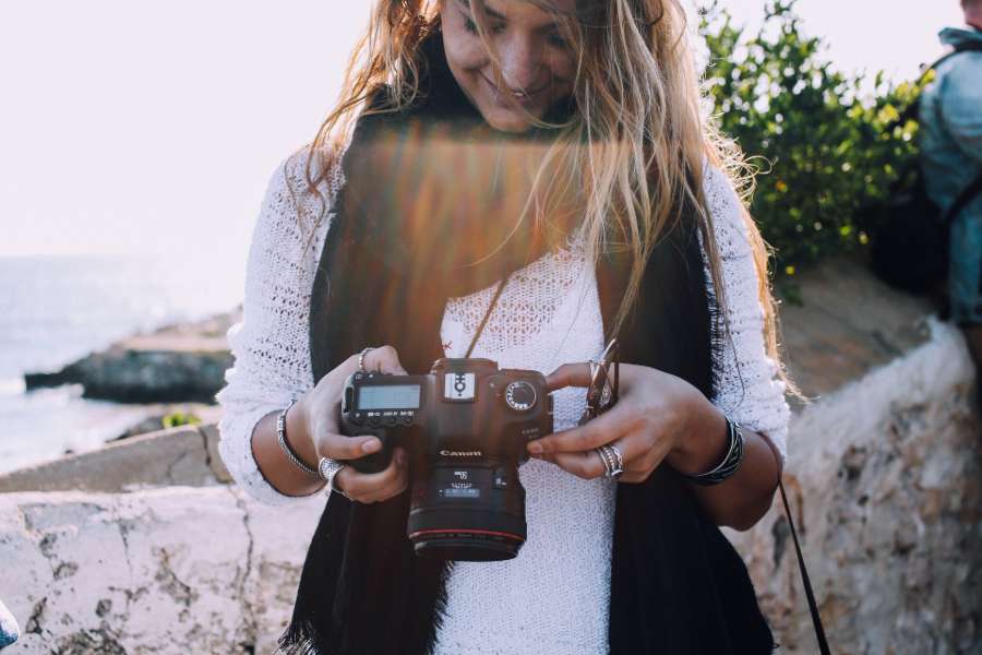 Woman smiling while looking at camera LCD