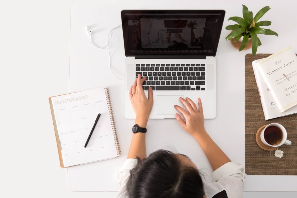 Person adjusting Photoshop settings in laptop to make it faster