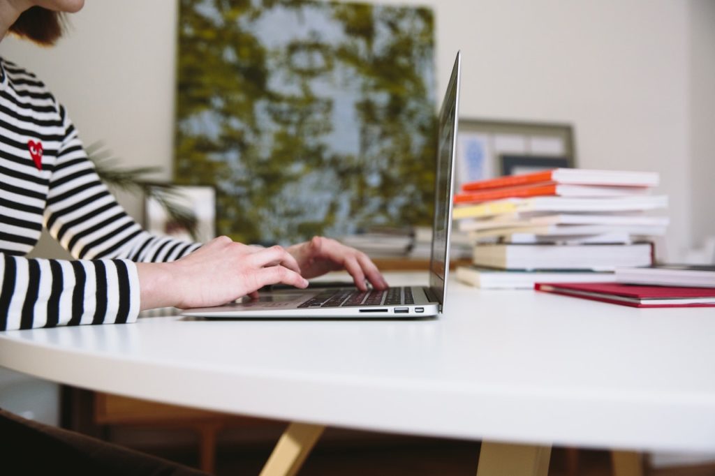 Man in striped shirt using a laptop