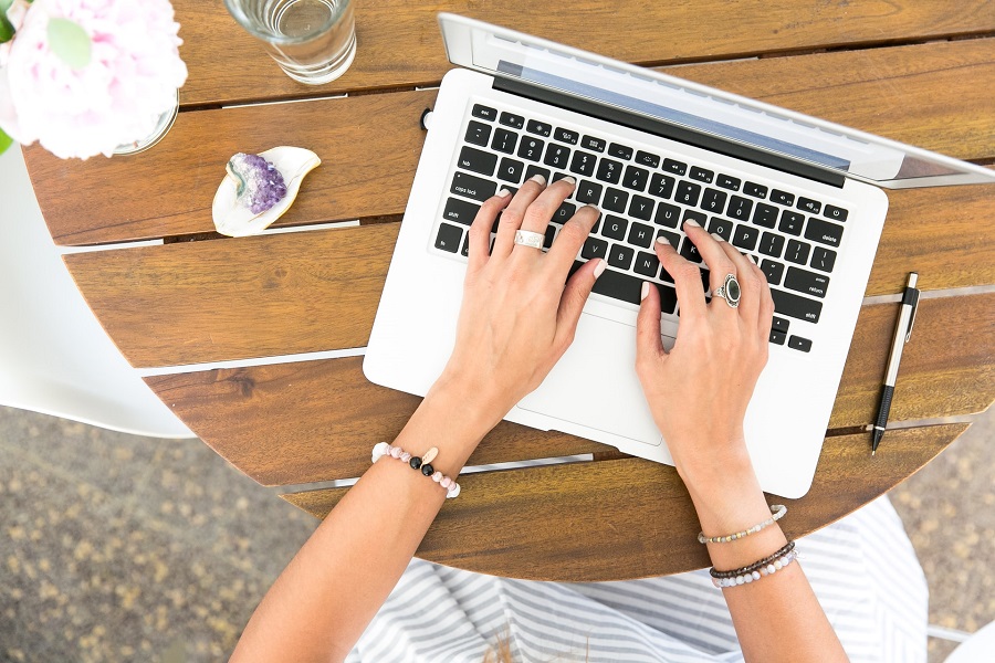 Person typing on a white macbook
