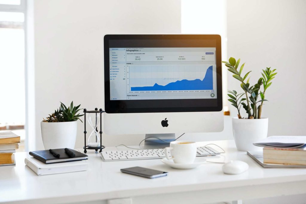 Computer screen on desk displaying a graph