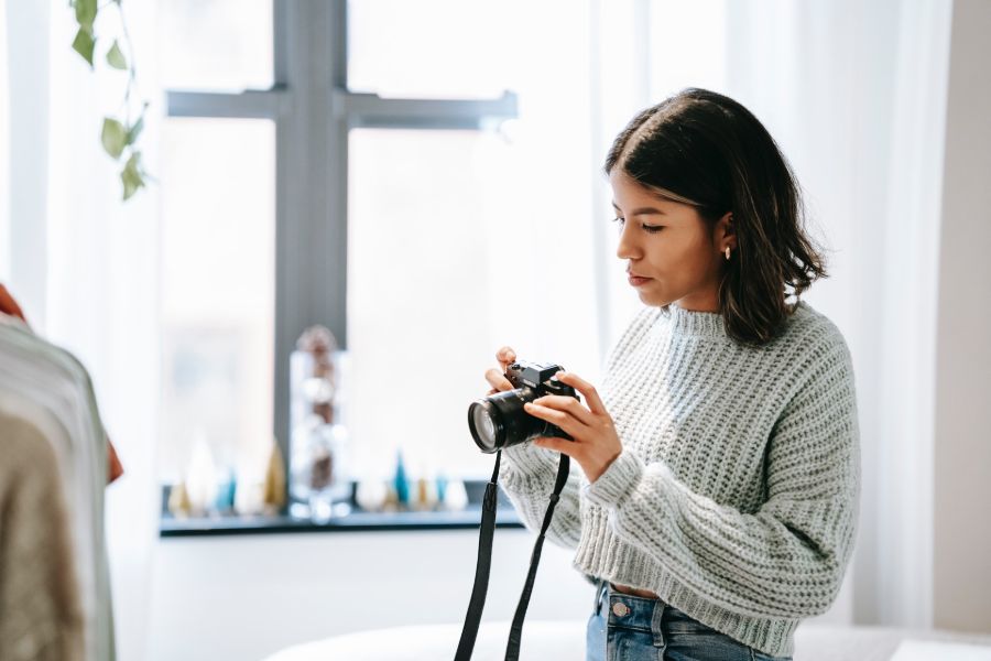 Woman viewing real estate interior photos in her camera