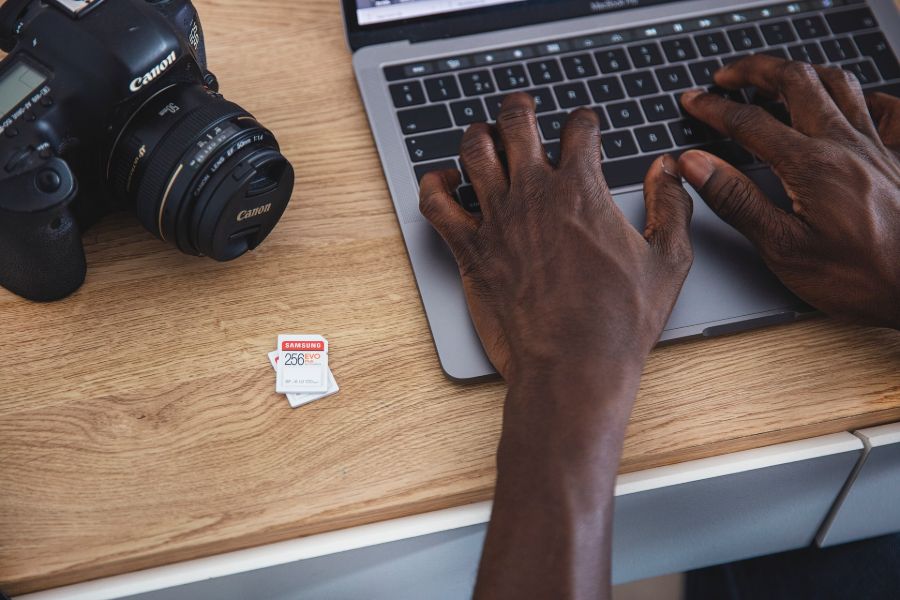 Man saving his real estate photos on a laptop
