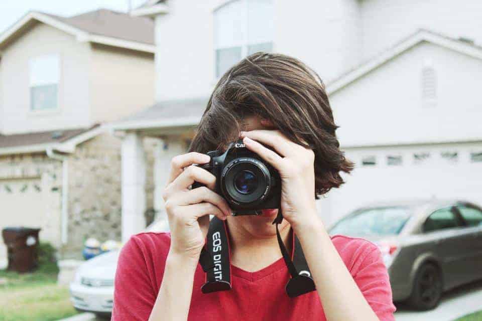 Woman wearing red shirt taking a photo