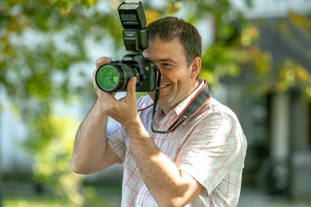 Man smiling while taking photos